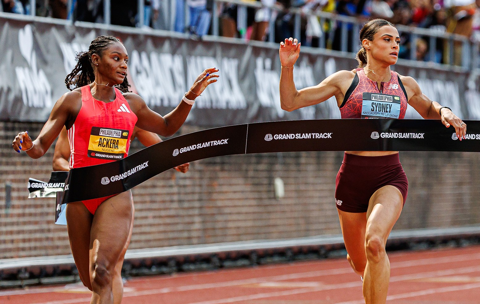 Sydney McLaughlin-Levrone and Ackera Nugent crossing the finish line at a Grand Slam Track meet in Philadelphia